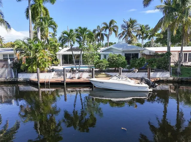 a view of a lake with a table and chairs