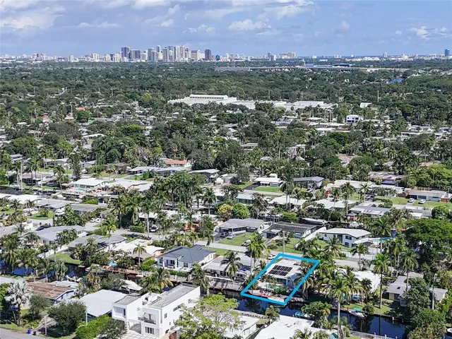 an aerial view of residential house with outdoor space and swimming pool