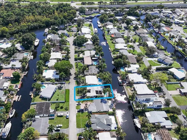 a view of a lake with boats and palm trees