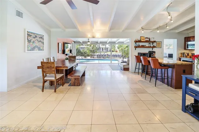 a dining room with furniture and a floor to ceiling window