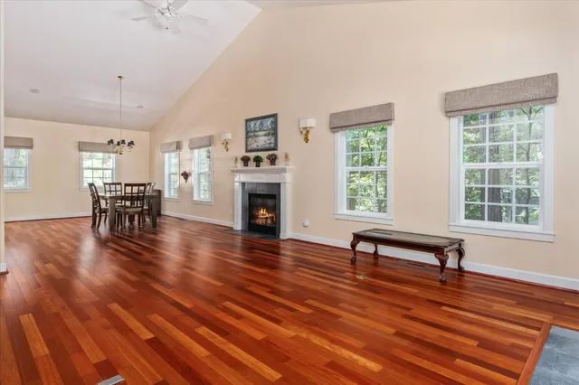 a living room with furniture wooden floor and a table