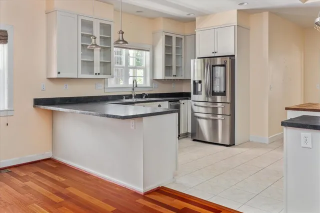 a kitchen with stainless steel appliances granite countertop a stove a sink and a refrigerator