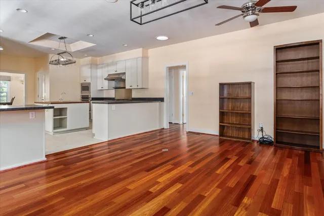 a view of a kitchen with wooden floor and a sink