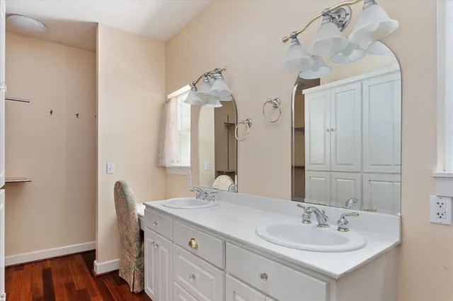 a bathroom with a double vanity sink and a mirror
