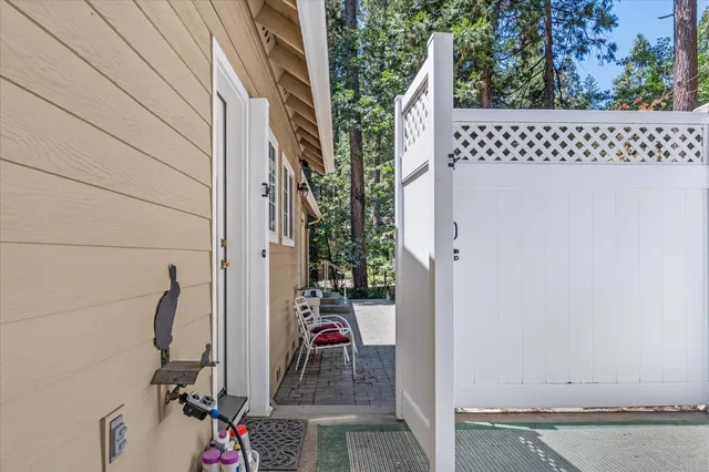 a view of backyard with outdoor seating and trees