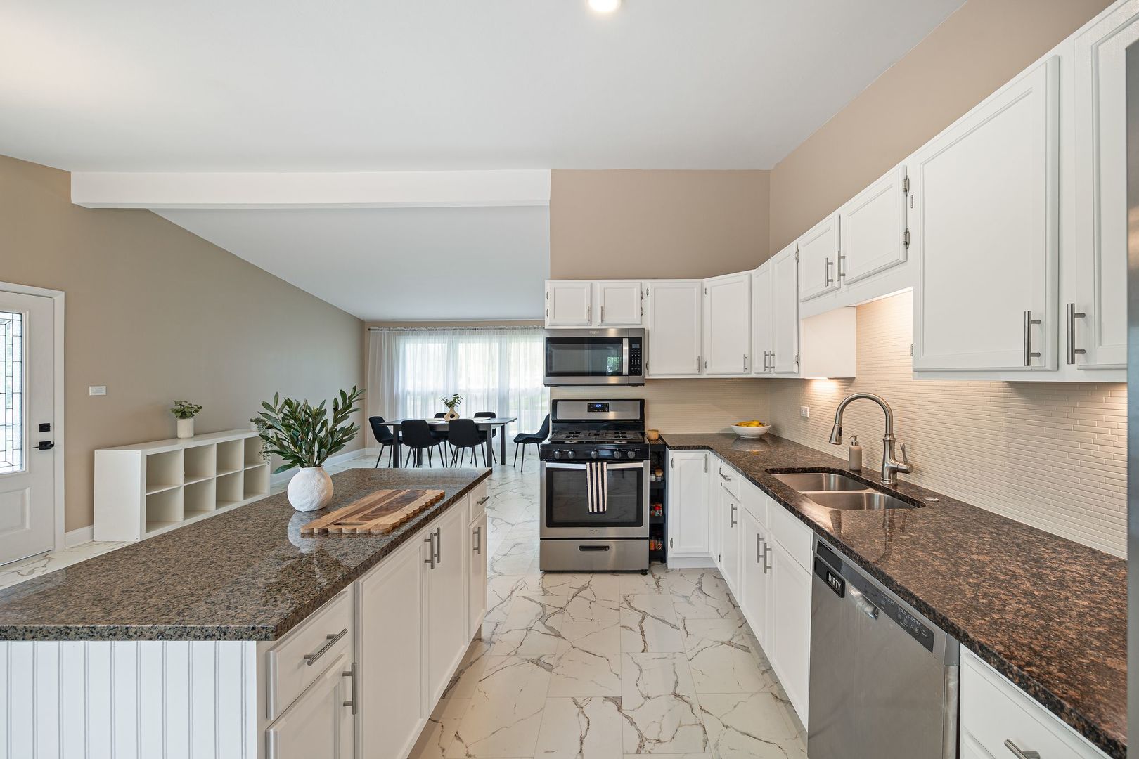 2117 Grouse Lane Rolling Meadows, IL 60008 - Photo 7 of 25 a large kitchen with granite countertop a sink and dishwasher a stove top oven with wooden floor