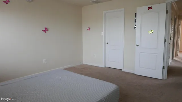 a bed sitting in a bedroom next to a window