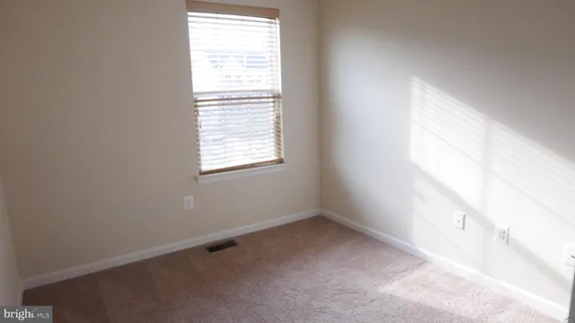 a bath room with a table and a window