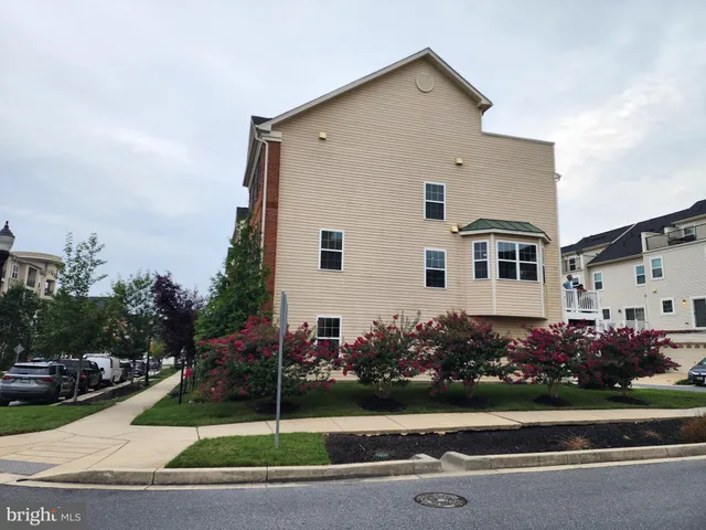 a front view of a house with a garden and plants