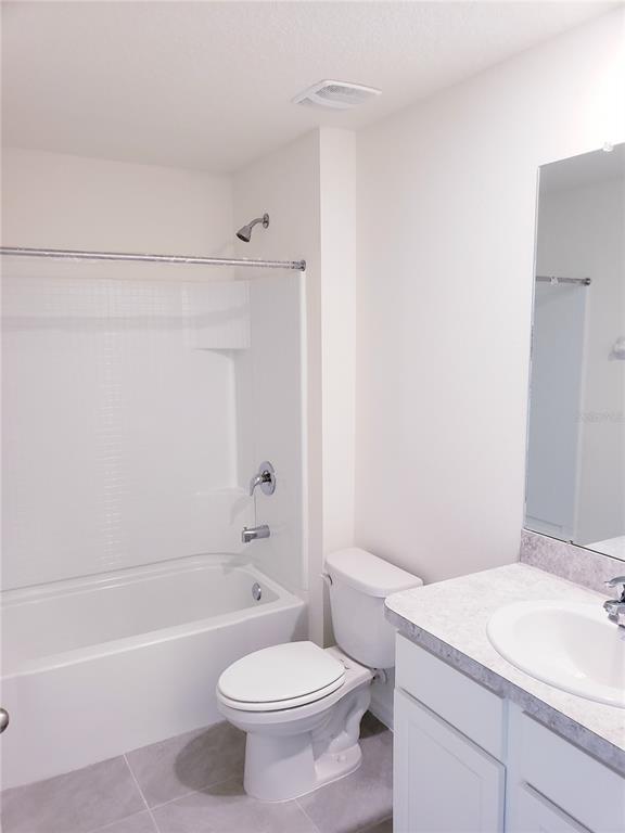 12211 Kingsley Trail Parrish, FL 34219 - Photo 27 of 28 a bathroom with a sink a toilet and a bathtub