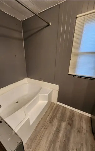 a bathroom with a bathtub and a shower