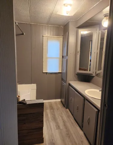 a hallway with a sink and a mirror