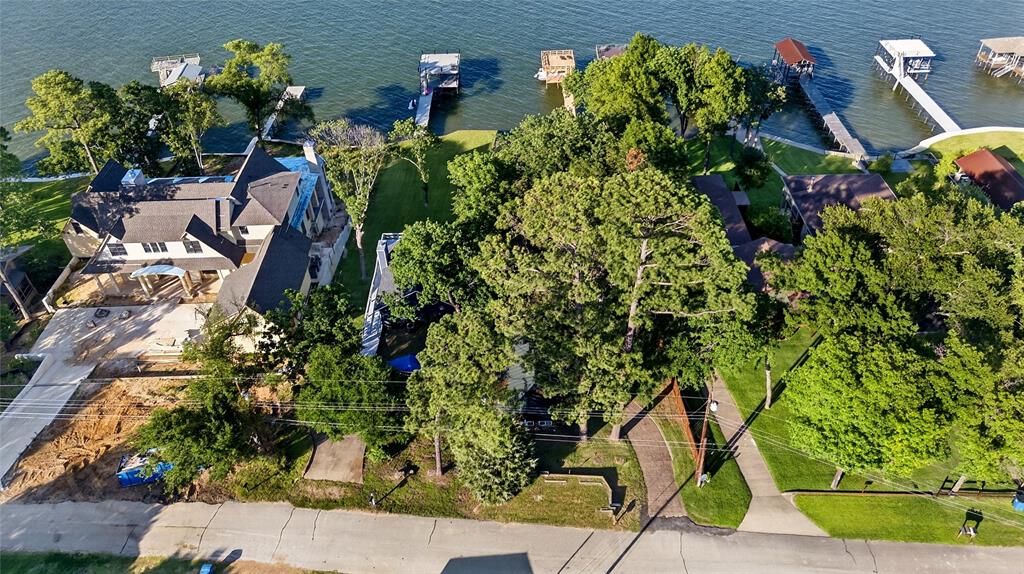 1113 Rim O The World Drive Tool, TX 75143 - Photo 35 of 40 Waterfront property featuring extensive tree cover, a multi-gabled roofline, and a private boat dock extending into the water.