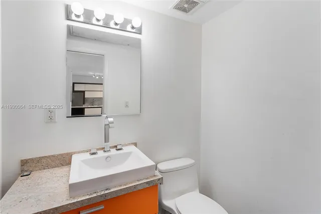 a bedroom with furniture and a flat screen tv