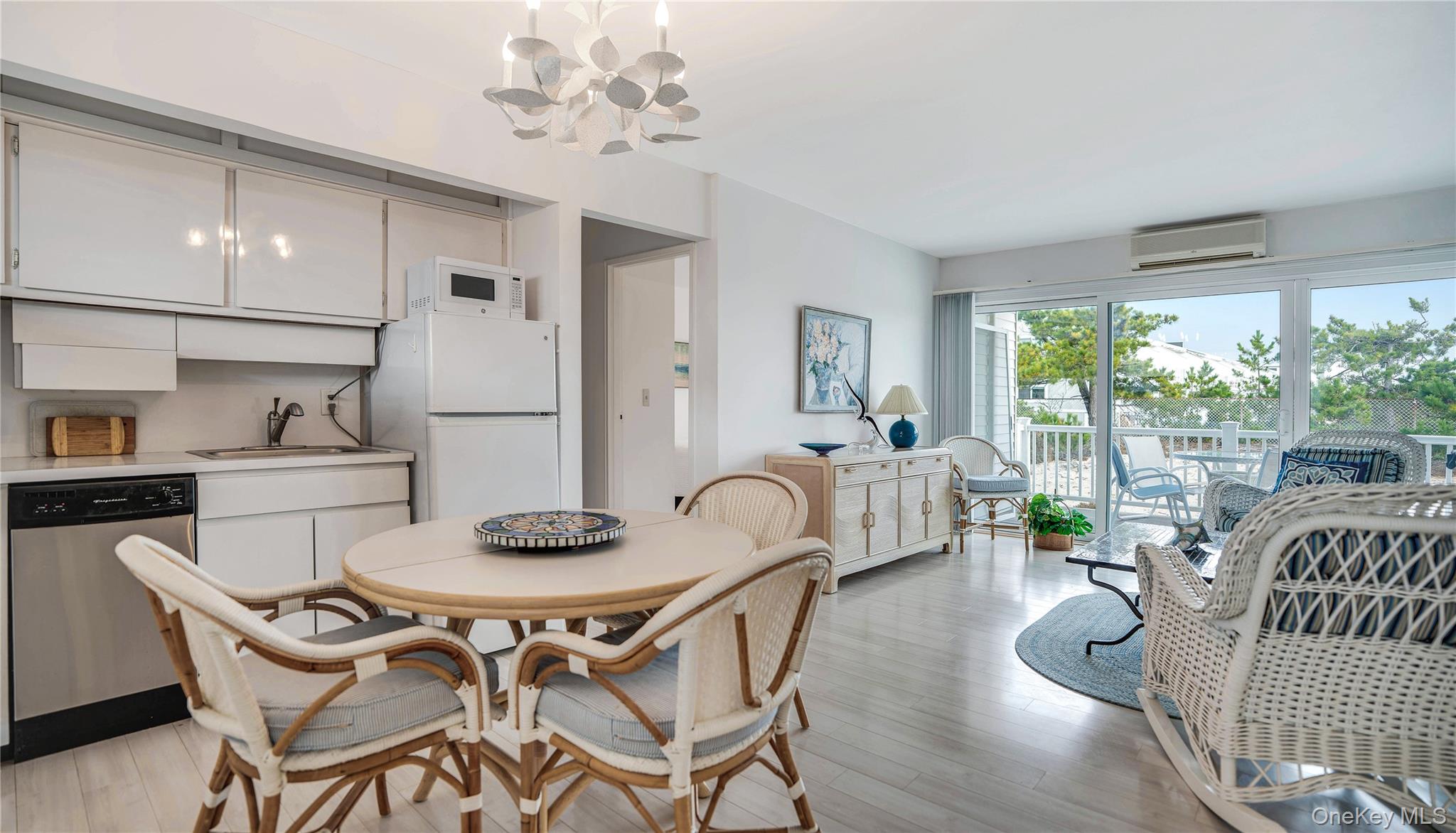 281 Dune Road, Unit 2A Westhampton Beach, NY 11978 - Photo 1 of 19 a view of a dining room with furniture window and outside view
