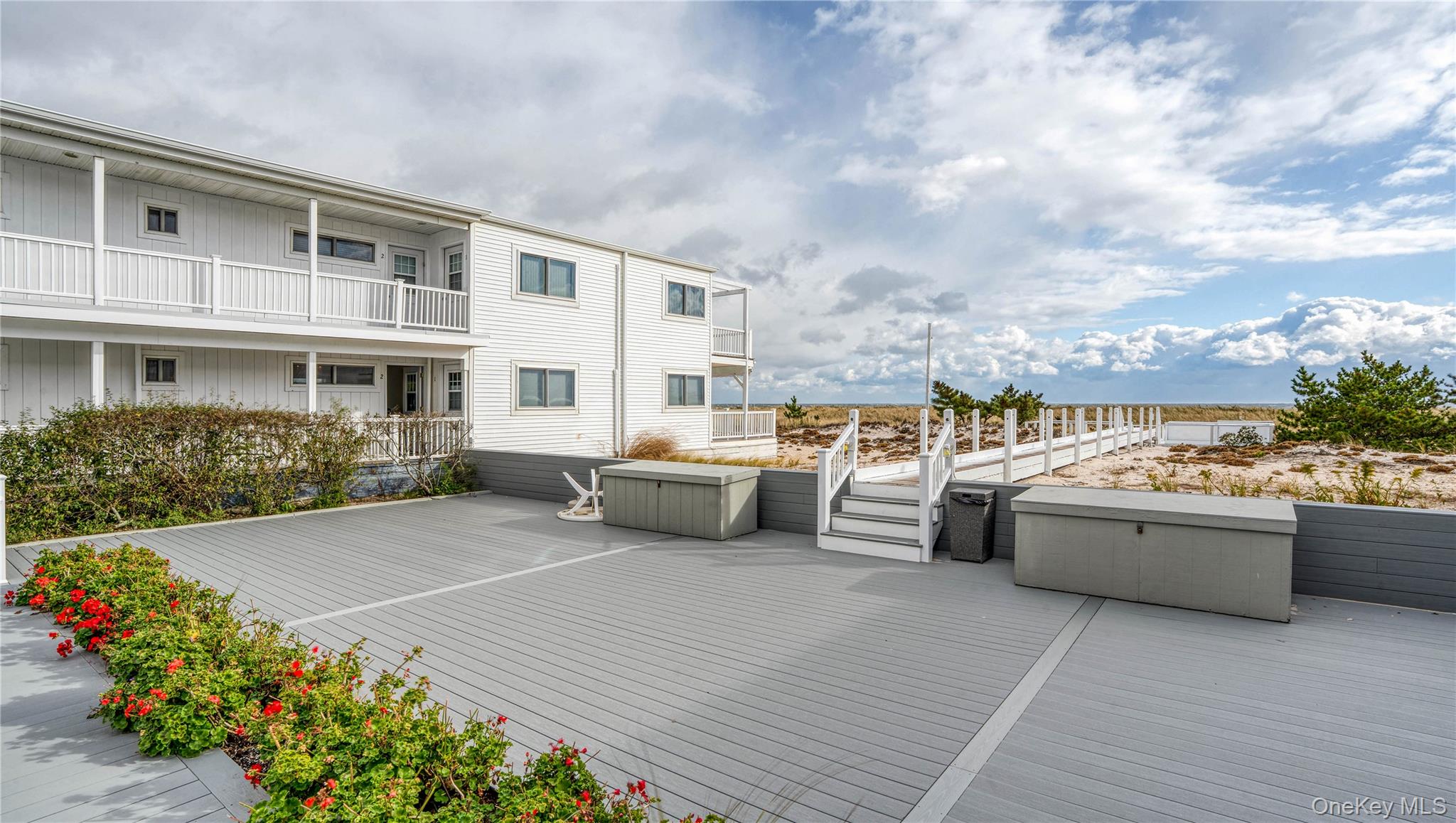 281 Dune Road, Unit 2A Westhampton Beach, NY 11978 - Photo 16 of 19 a view of a terrace with chairs and potted plants