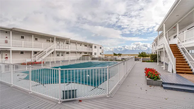 a view of a balcony with wooden floor and fence
