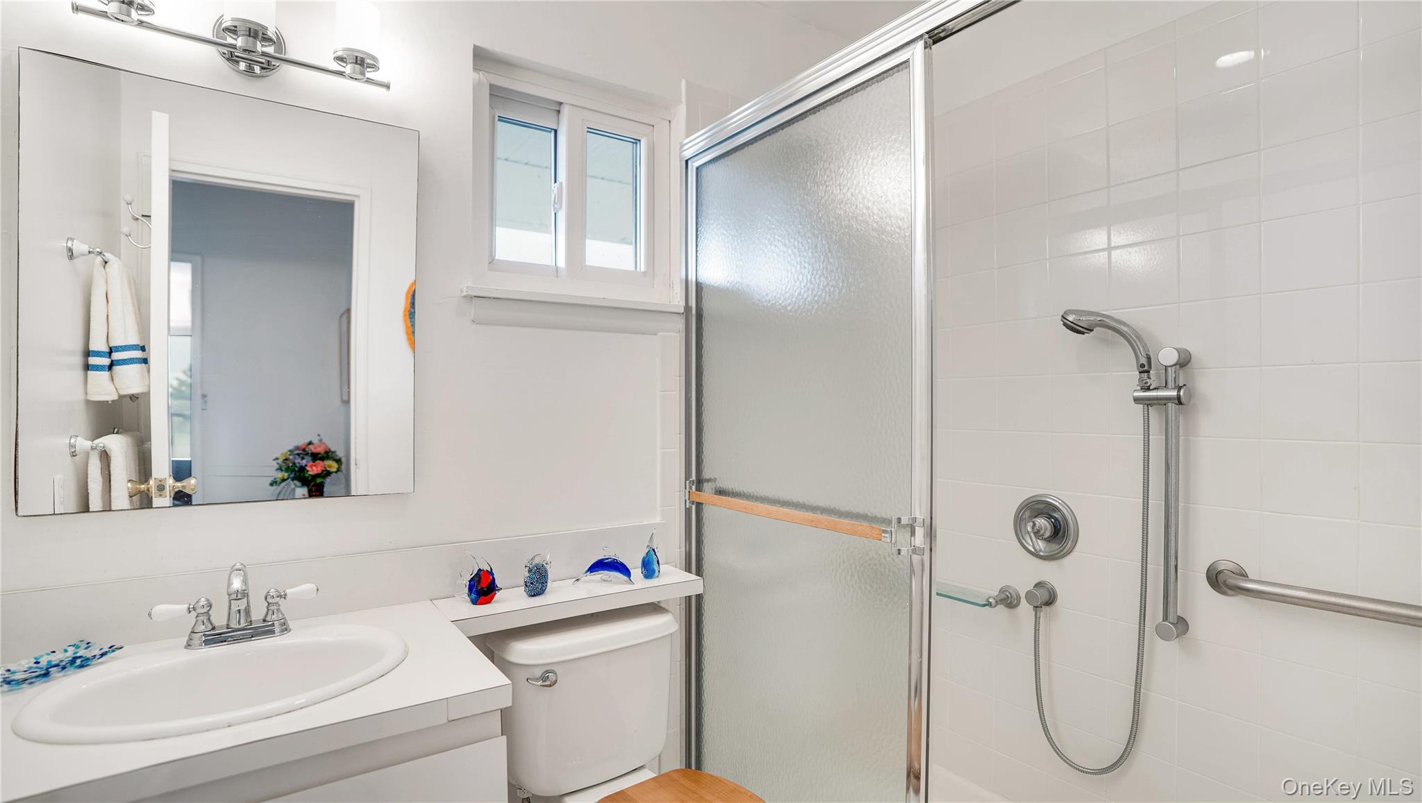 281 Dune Road, Unit 2A Westhampton Beach, NY 11978 - Photo 8 of 19 a bathroom with a sink toilet and shower