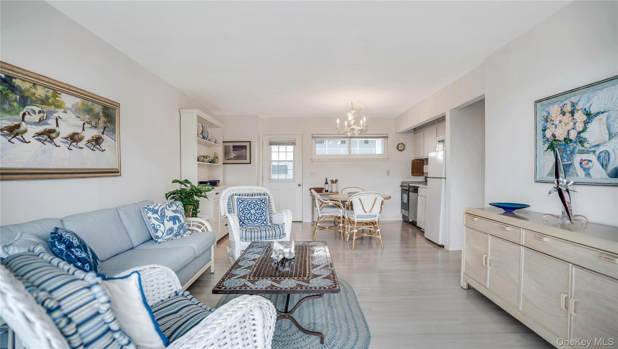 281 Dune Road, Unit 2A Westhampton Beach, NY 11978 - Photo 10 of 19 a living room with furniture and a dining table with kitchen view