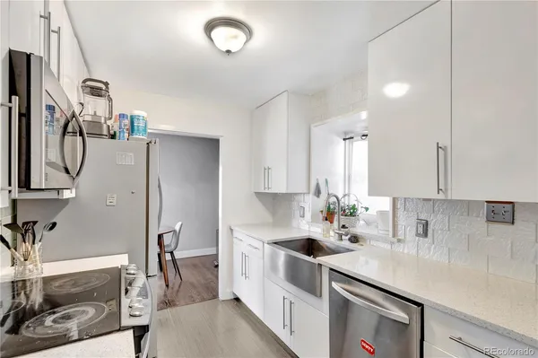 a kitchen with stainless steel appliances a sink stove and refrigerator
