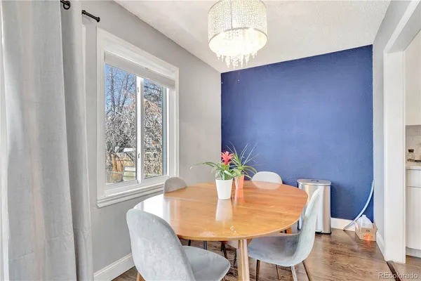a view of a dining room with furniture and a chandelier