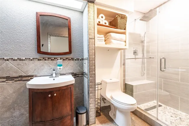 a bathroom with a toilet a sink and mirror
