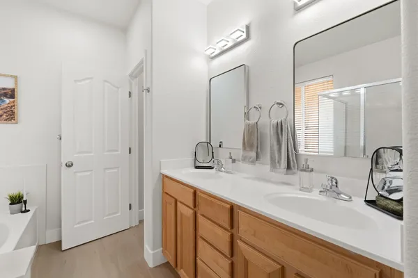 a bathroom with a double vanity sink and a mirror