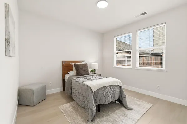 a bedroom with a bed and a window
