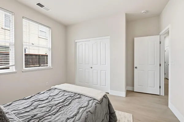 a bedroom with a bed and a window