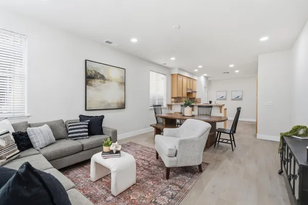 a living room with furniture and a wooden floor