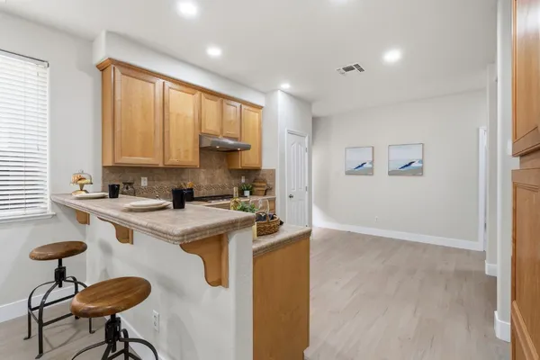 a kitchen with stainless steel appliances granite countertop a stove a sink and a refrigerator