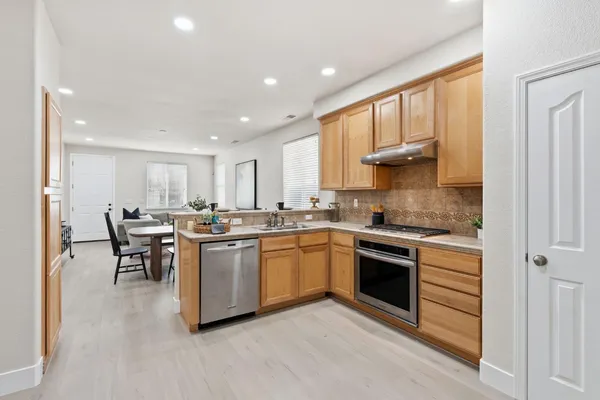 a kitchen with a sink stainless steel appliances and cabinets