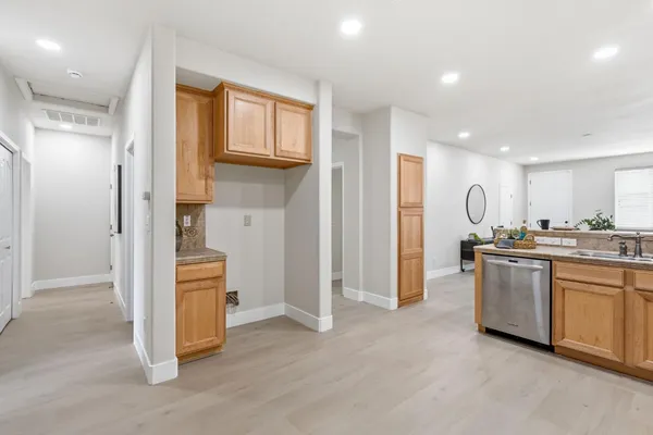 a view of kitchen with stainless steel appliances granite countertop refrigerator and stove