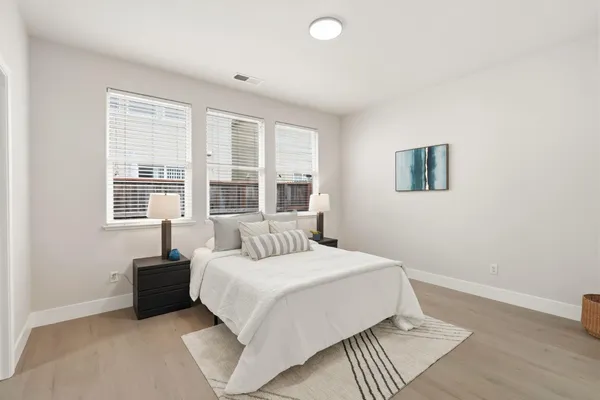 a bedroom with a bed and a large window