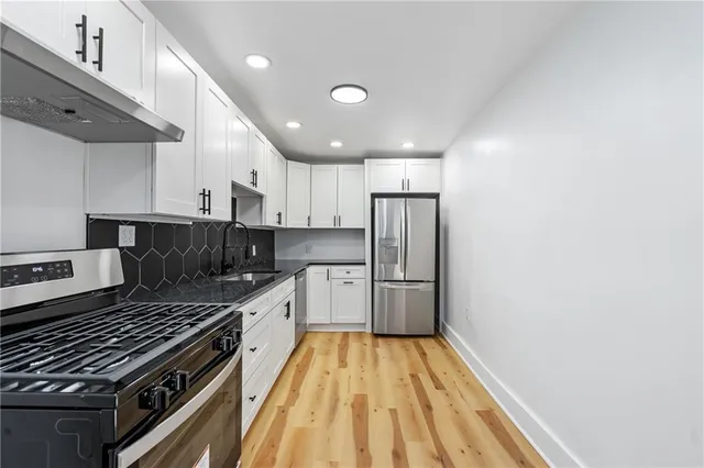 a kitchen with a stove a sink and a refrigerator