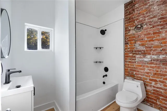 a bathroom with a toilet a sink and a bathtub