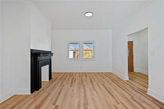 a view of a livingroom with wooden floor and a window