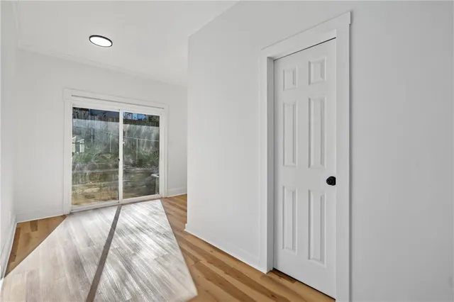 a view of a room with wooden floor and windows