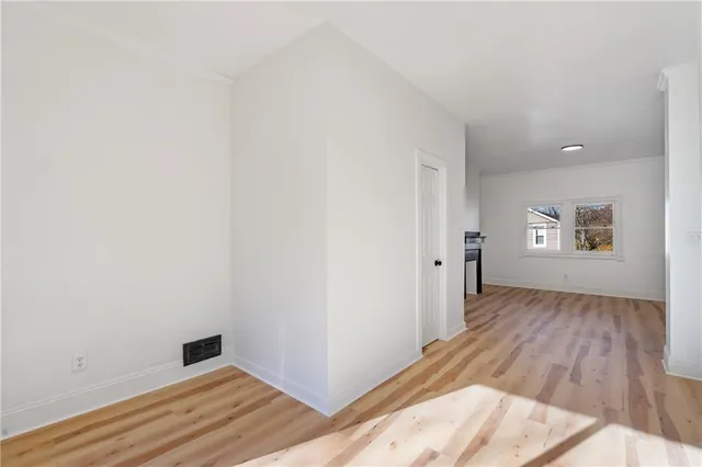 a view of a room with wooden floor and white doors