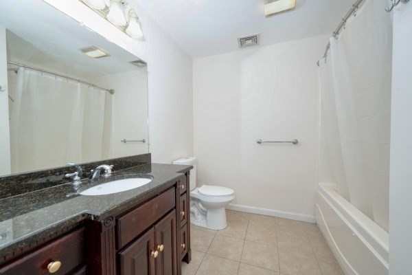 117 Tamarack Lane, Unit 117 Abington, MA 02351 - Photo 16 of 26 a bathroom with a granite countertop sink a toilet and a mirror