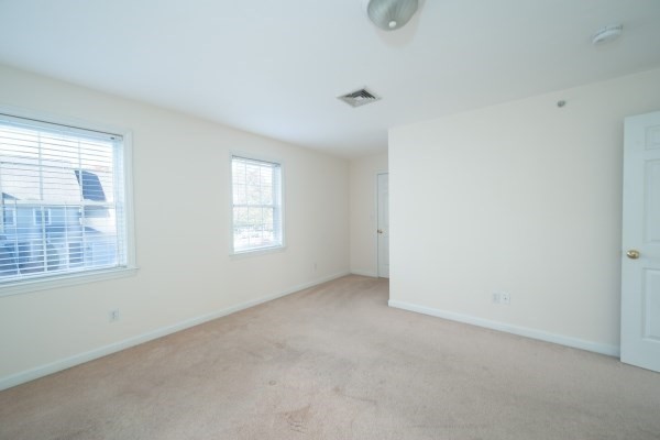117 Tamarack Lane, Unit 117 Abington, MA 02351 - Photo 19 of 26 an empty room with windows