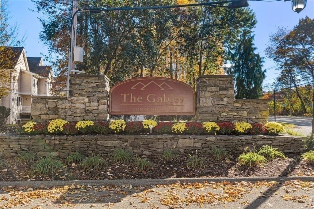 117 Tamarack Lane, Unit 117 Abington, MA 02351 - Photo 26 of 26 a sign that is sitting on a brick wall