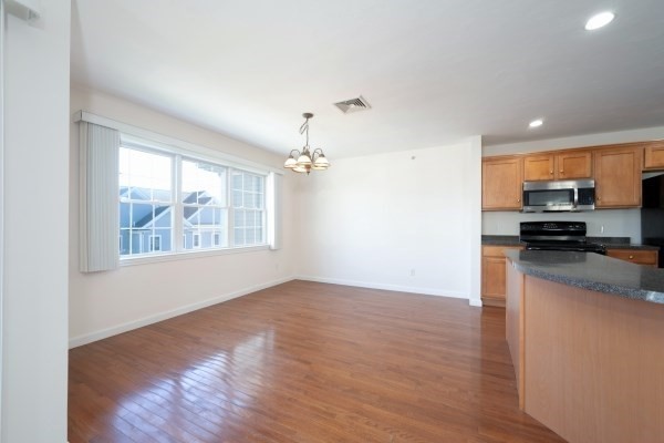 117 Tamarack Lane, Unit 117 Abington, MA 02351 - Photo 9 of 26 a view of a kitchen with a sink wooden floor and a window