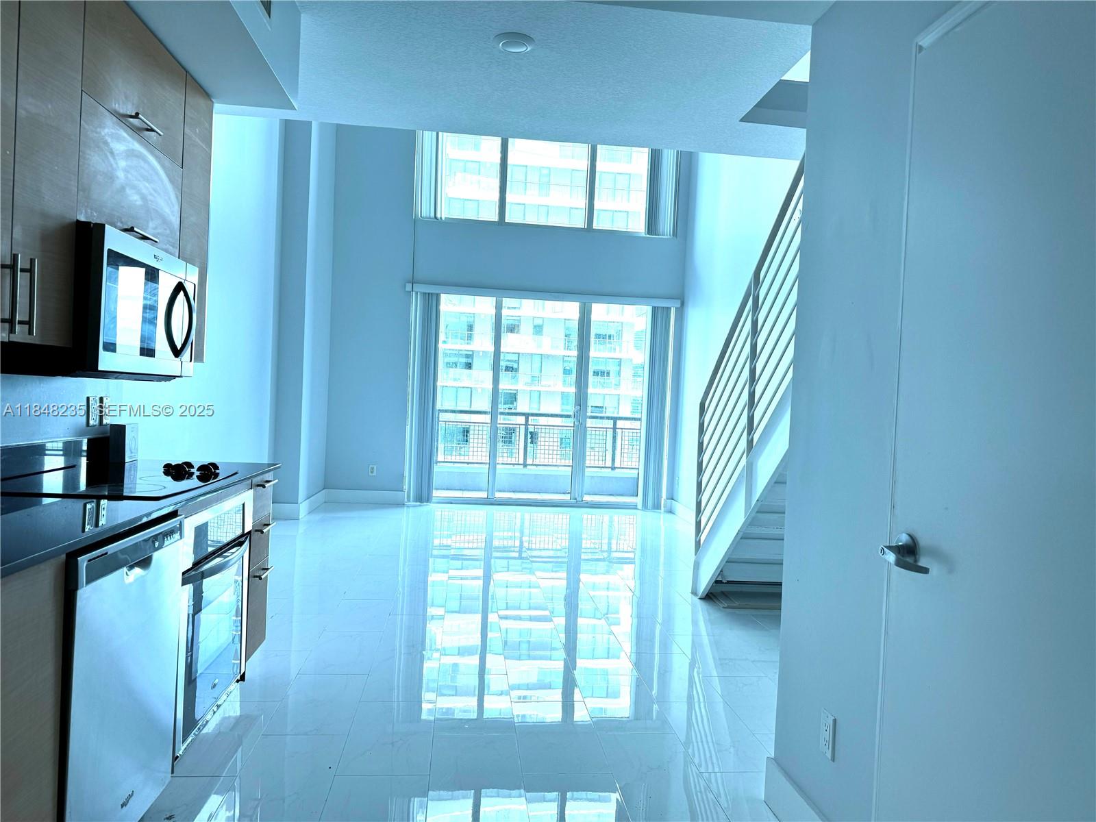 60 Southwest 13th Street, Unit 3408 Miami, FL 33130 - Photo 1 of 27 a view of a kitchen from the hallway