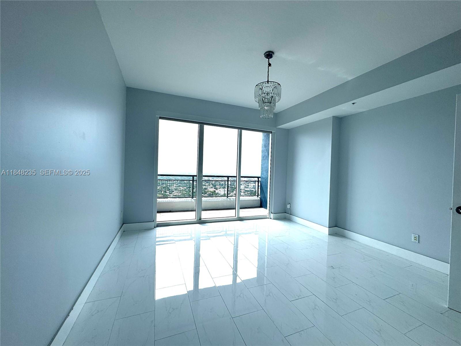 60 Southwest 13th Street, Unit 3408 Miami, FL 33130 - Photo 17 of 27 wooden floor in an empty room with a window