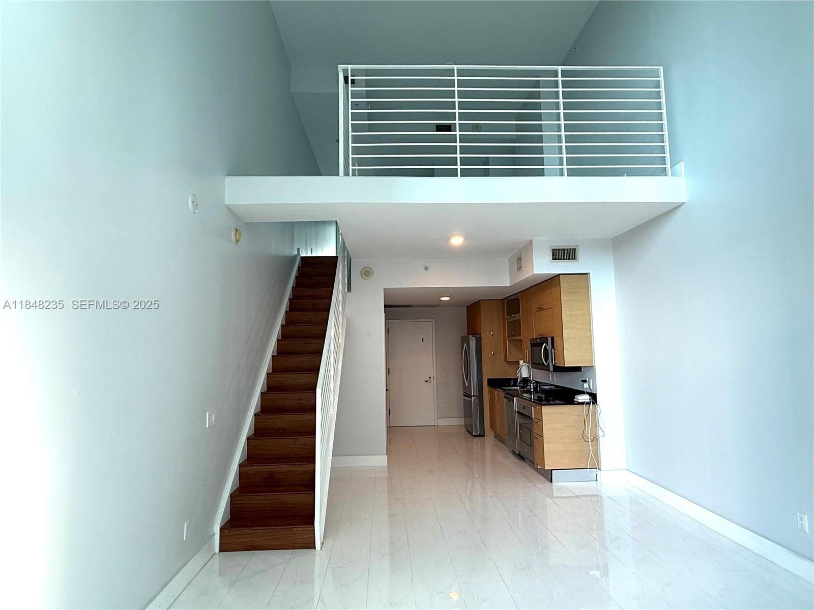 60 Southwest 13th Street, Unit 3408 Miami, FL 33130 - Photo 17 of 27 a view of kitchen with furniture and stainless steel appliances