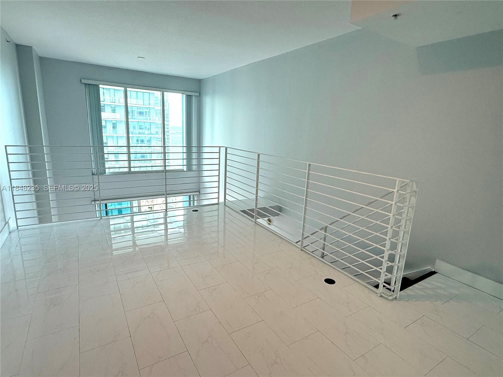 60 Southwest 13th Street, Unit 3408 Miami, FL 33130 - Photo 19 of 27 a view of an empty room with stairs