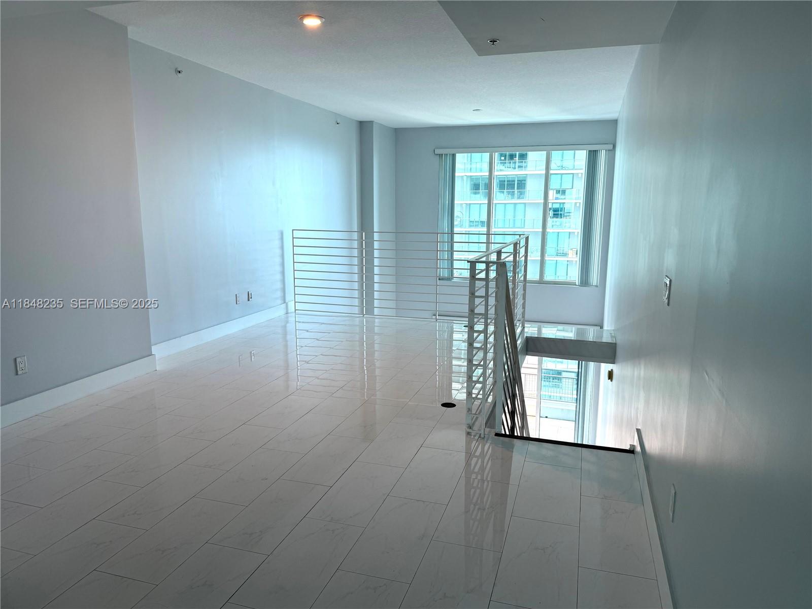 60 Southwest 13th Street, Unit 3408 Miami, FL 33130 - Photo 21 of 27 a view of empty room with floor to ceiling window