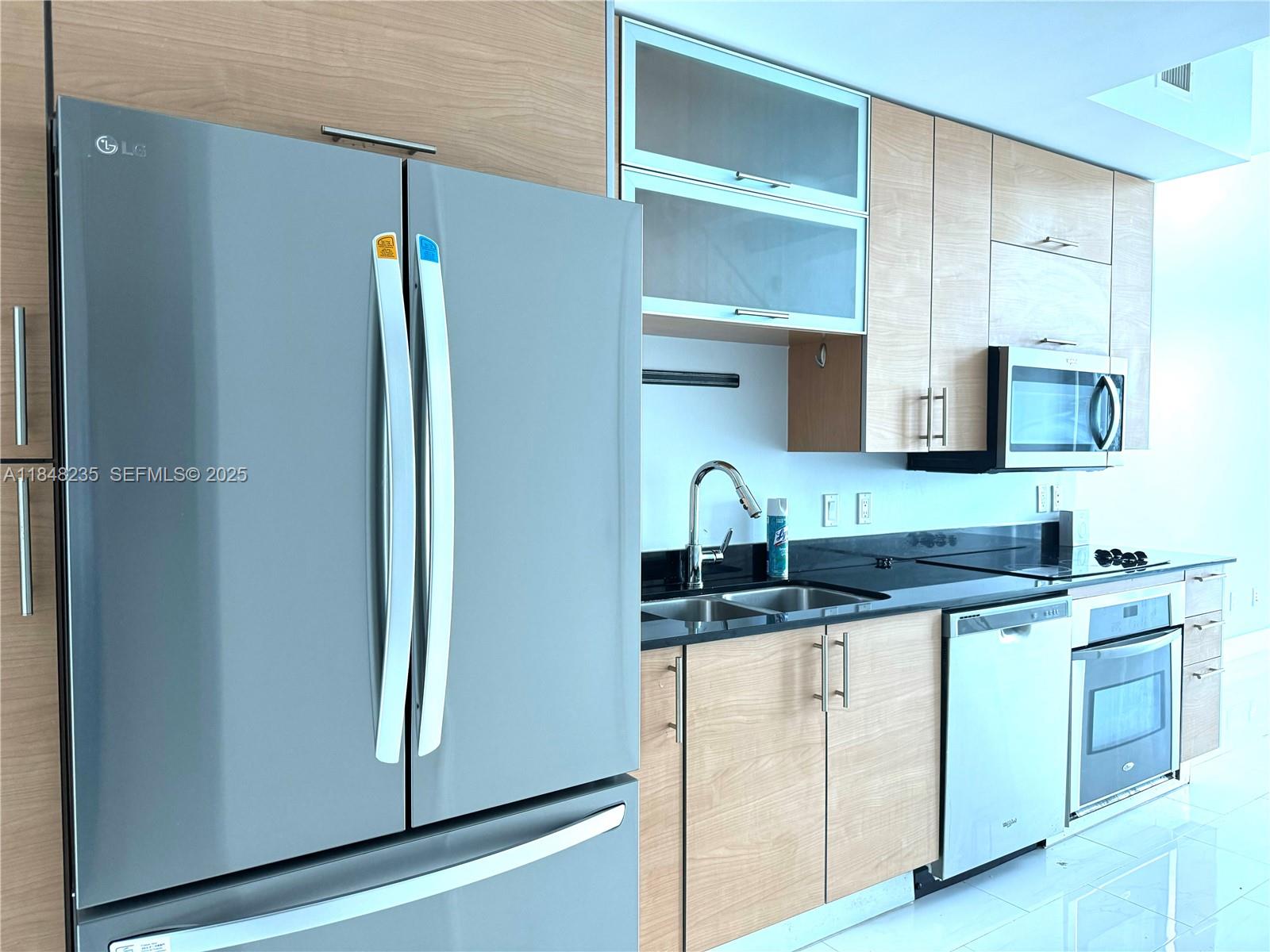 60 Southwest 13th Street, Unit 3408 Miami, FL 33130 - Photo 3 of 27 a kitchen with stainless steel appliances granite countertop a refrigerator and a sink