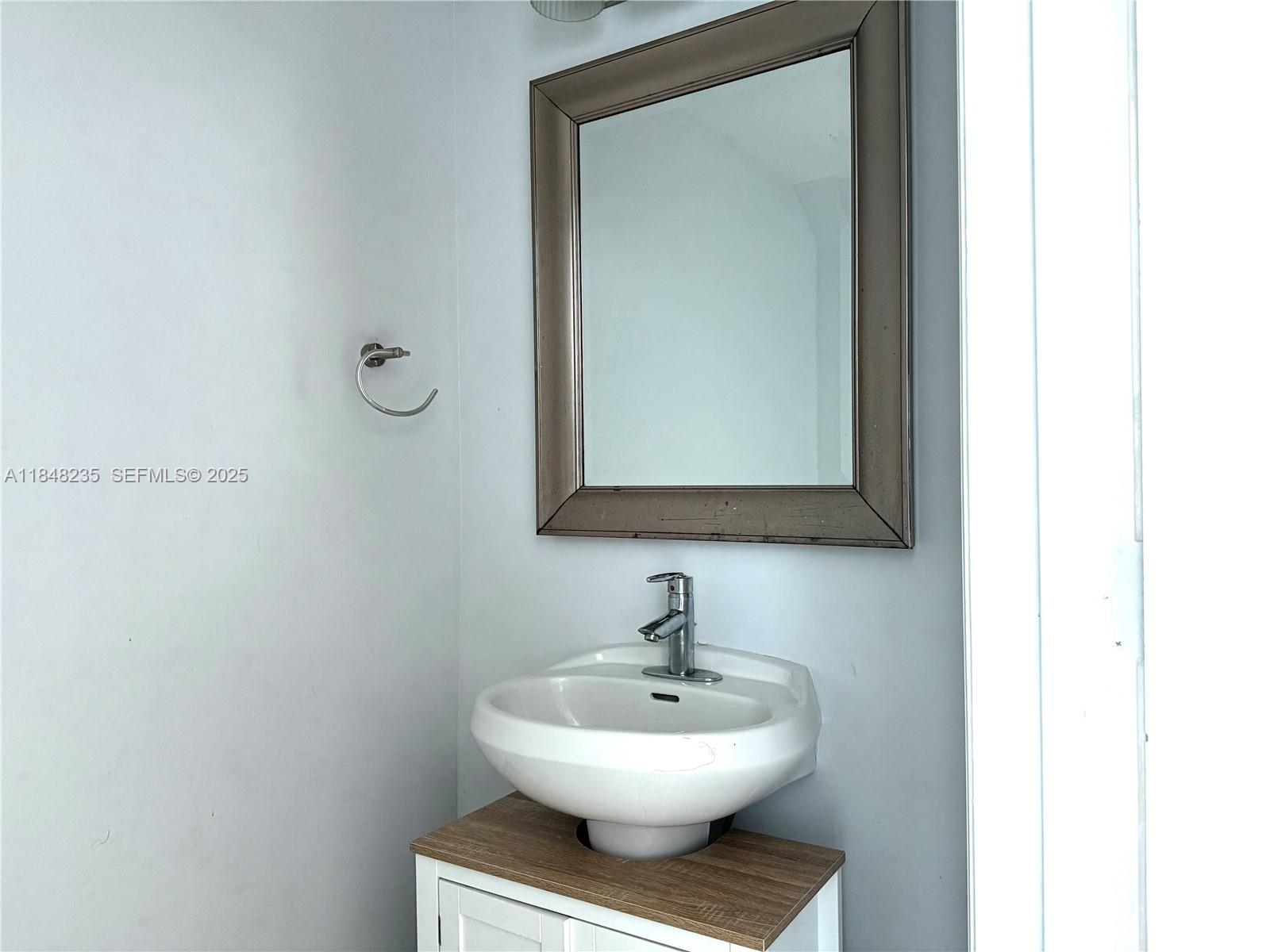 60 Southwest 13th Street, Unit 3408 Miami, FL 33130 - Photo 4 of 27 a bathroom with a toilet a sink and mirror